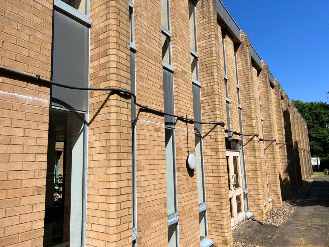 External armoured cabling on a commercial building